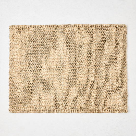 Rectangular natural woven abaca placemat in a honey-brown hue, 19"L x 14"W.