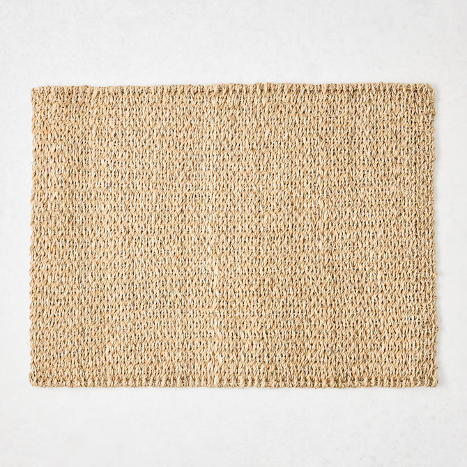 Rectangular natural woven abaca placemat in a honey-brown hue, 19"L x 14"W.
