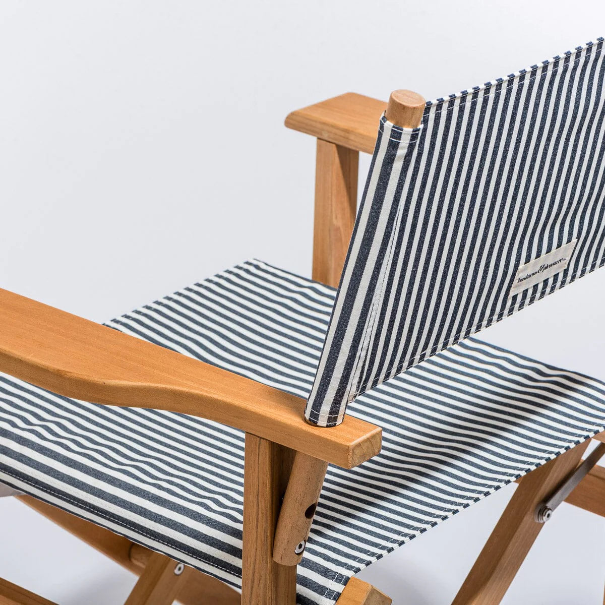 Navy and white stripe directors chair with a painted teakwood frame.