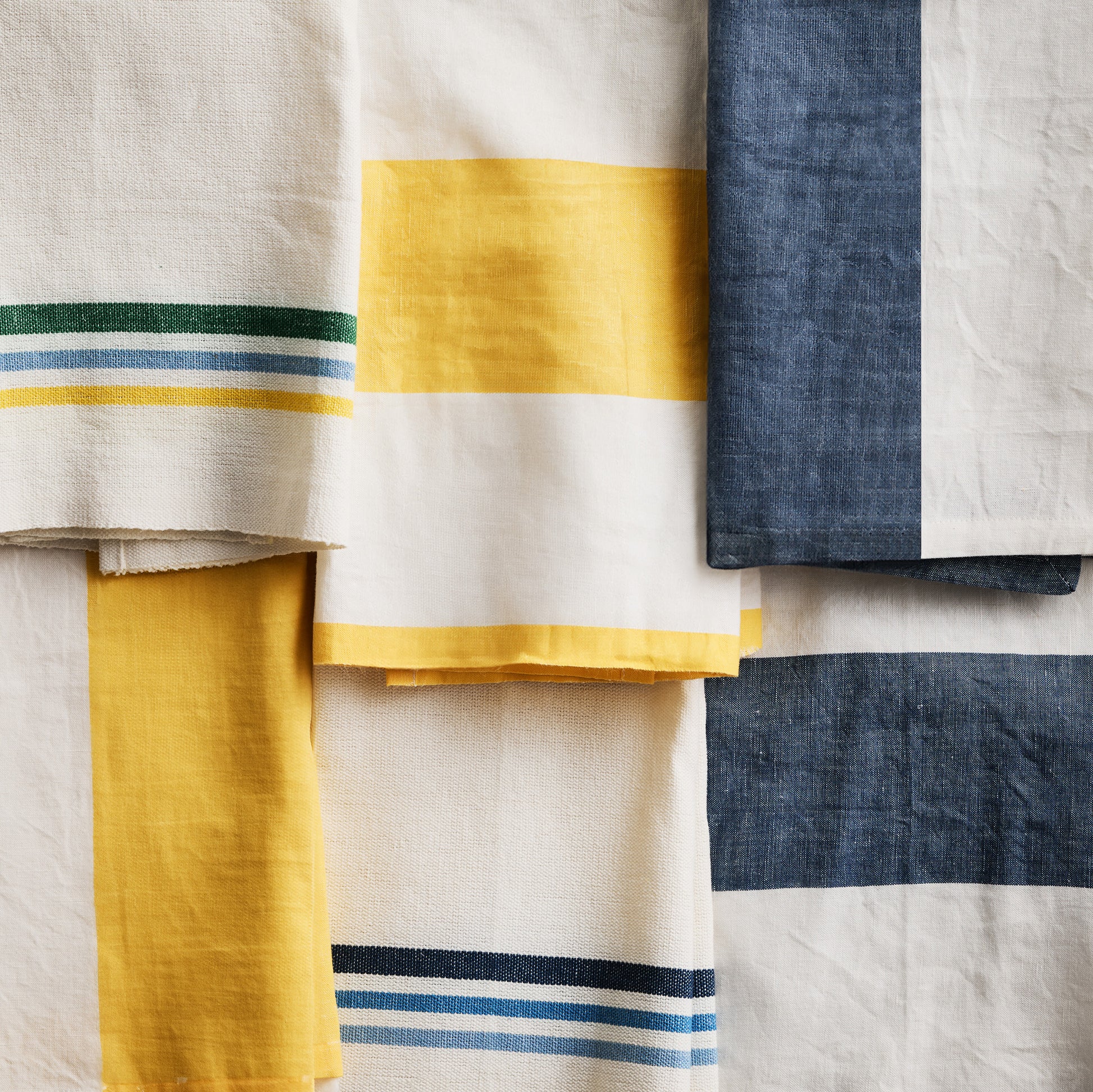 Navy and white block print hand towels, set of 2, with stripe and half-pattern designs.