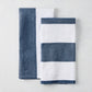 Two navy and white cotton-linen hand towels: one half-navy, half-white; one navy and white striped.