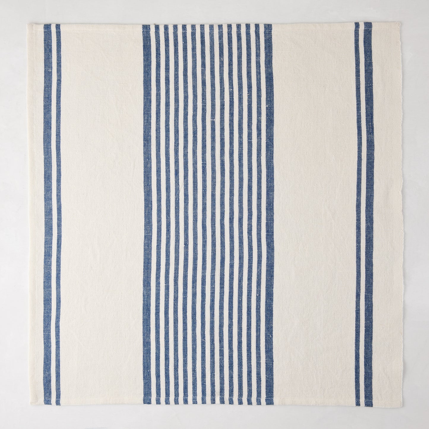 Navy Boat Stripe Napkin, 22" square, woven cotton-linen blend with vertical blue and white stripes.
