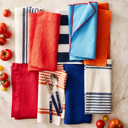 Navy Boat Stripe Napkin, 22" square, cotton-linen blend, with red, blue, and white striped napkins.