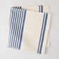 Navy Boat Stripe Napkin, 22" square, folded, 50% cotton, 50% linen.