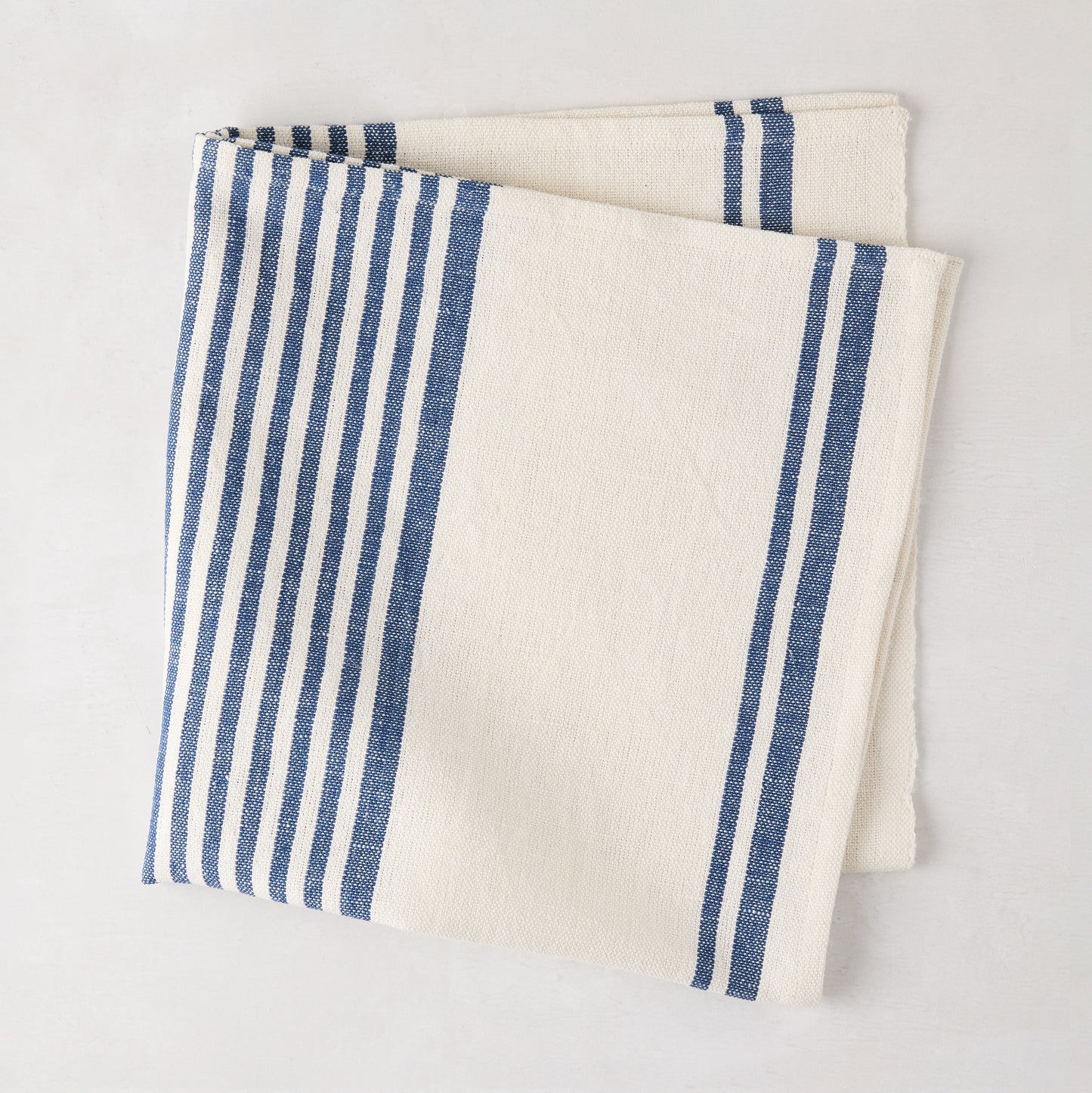 Navy Boat Stripe Napkin, 22" square, folded, 50% cotton, 50% linen.