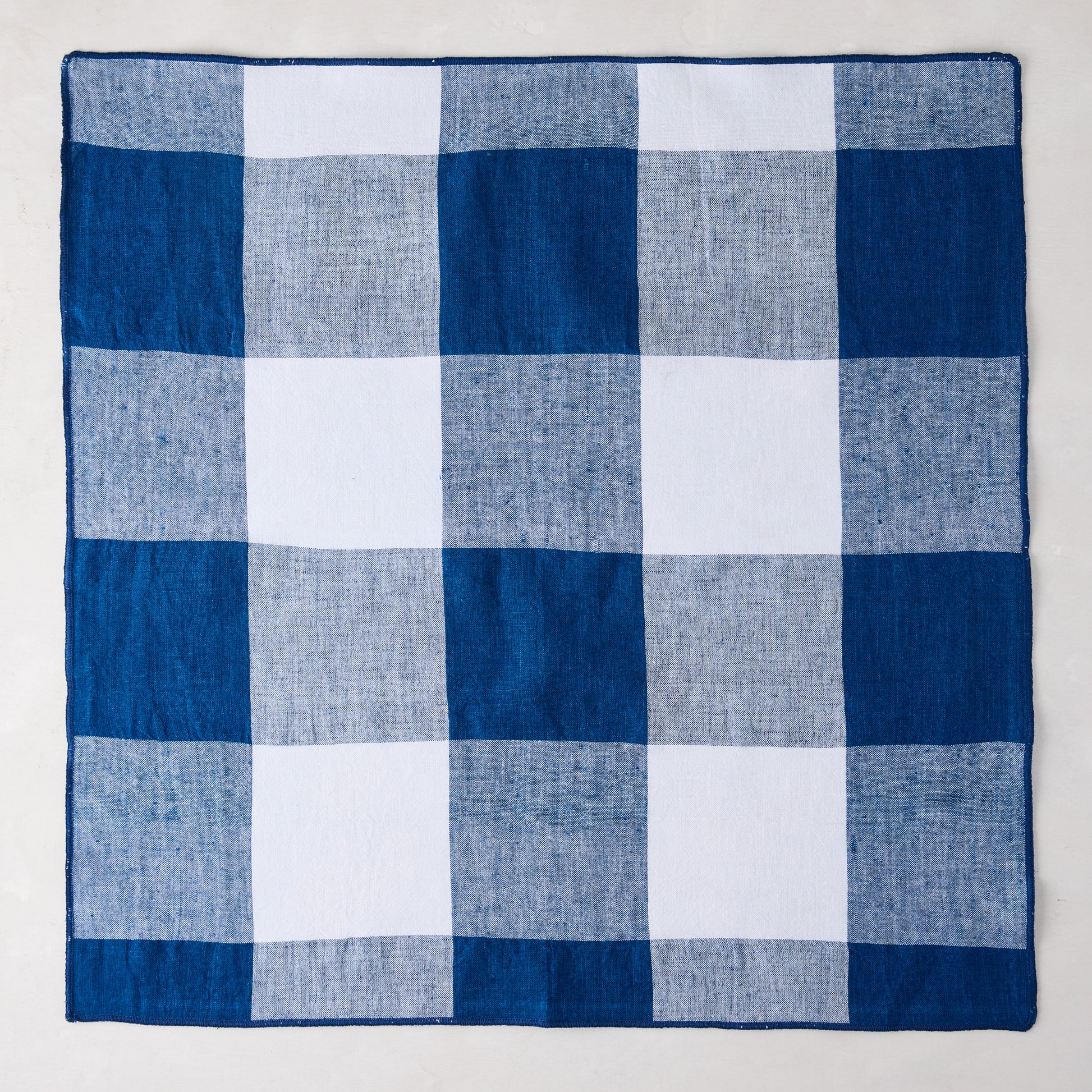 Navy Blue Buffalo Check Linen Napkin, 20" x 20", folded square.