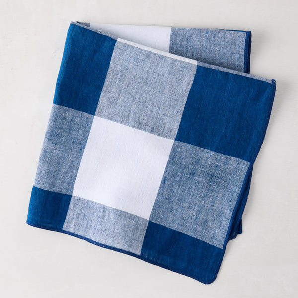 Navy Blue Buffalo Check Linen Napkin, 20" x 20", folded on a white surface.
