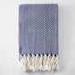 Navy blue and white chevron cotton throw blanket with thick rope fringe.
