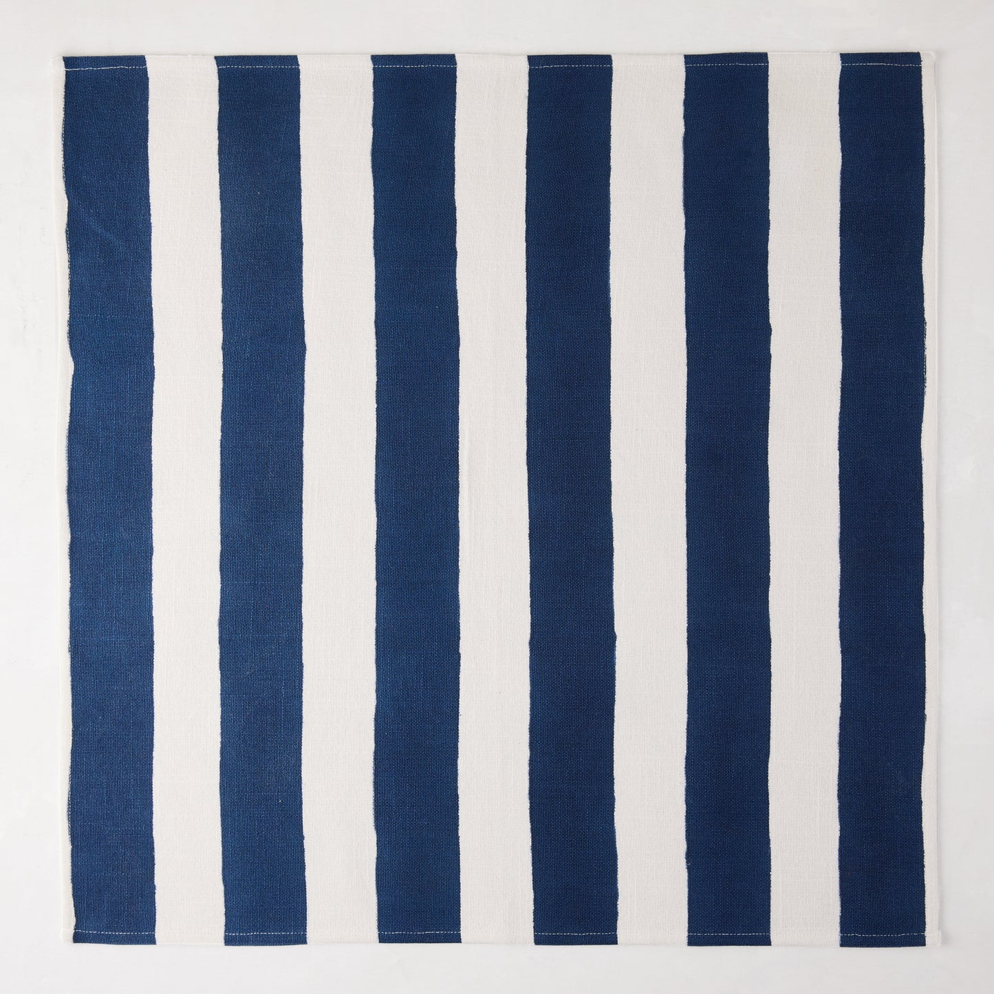 Navy Hampton Stripe Cotton Napkin, 22" square, with thick vertical navy and white stripes.