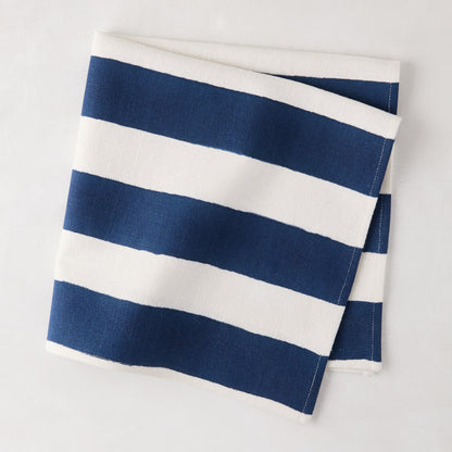 Folded Navy Hampton Stripe Cotton Napkin, 22" square, with thick blue and white stripes.