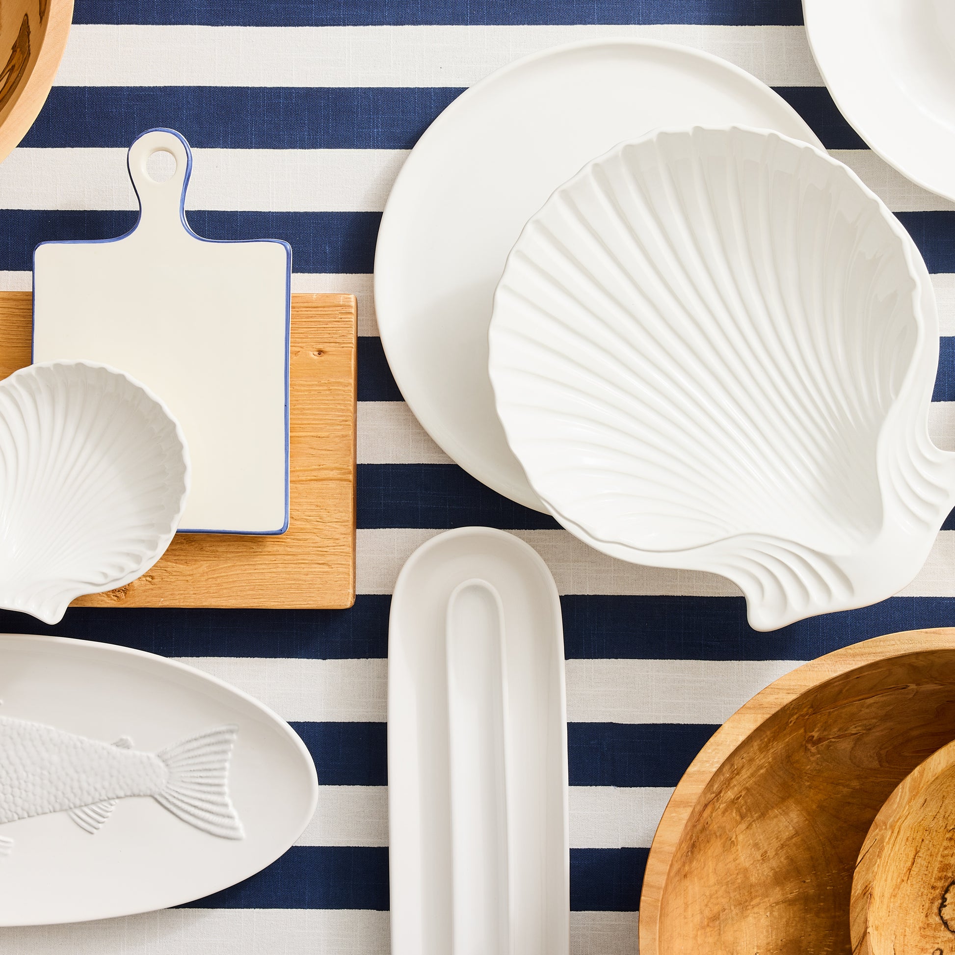 Navy Hampton Stripe Tablecloth, 100% cotton, with white and navy stripes, styled with white dinnerware.