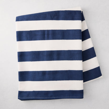 Navy Hampton Stripe Tablecloth, 100% cotton, folded, with bold navy and white horizontal stripes.