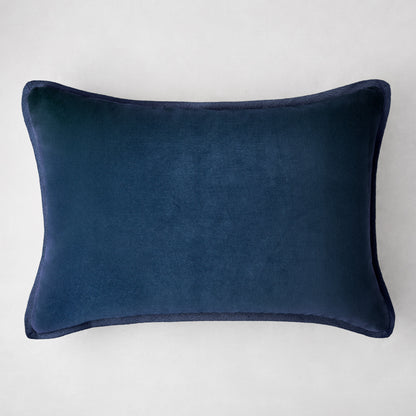 Navy blue linen and velvet reversible lumbar pillow, 20"L x 14"H, with piped edges.