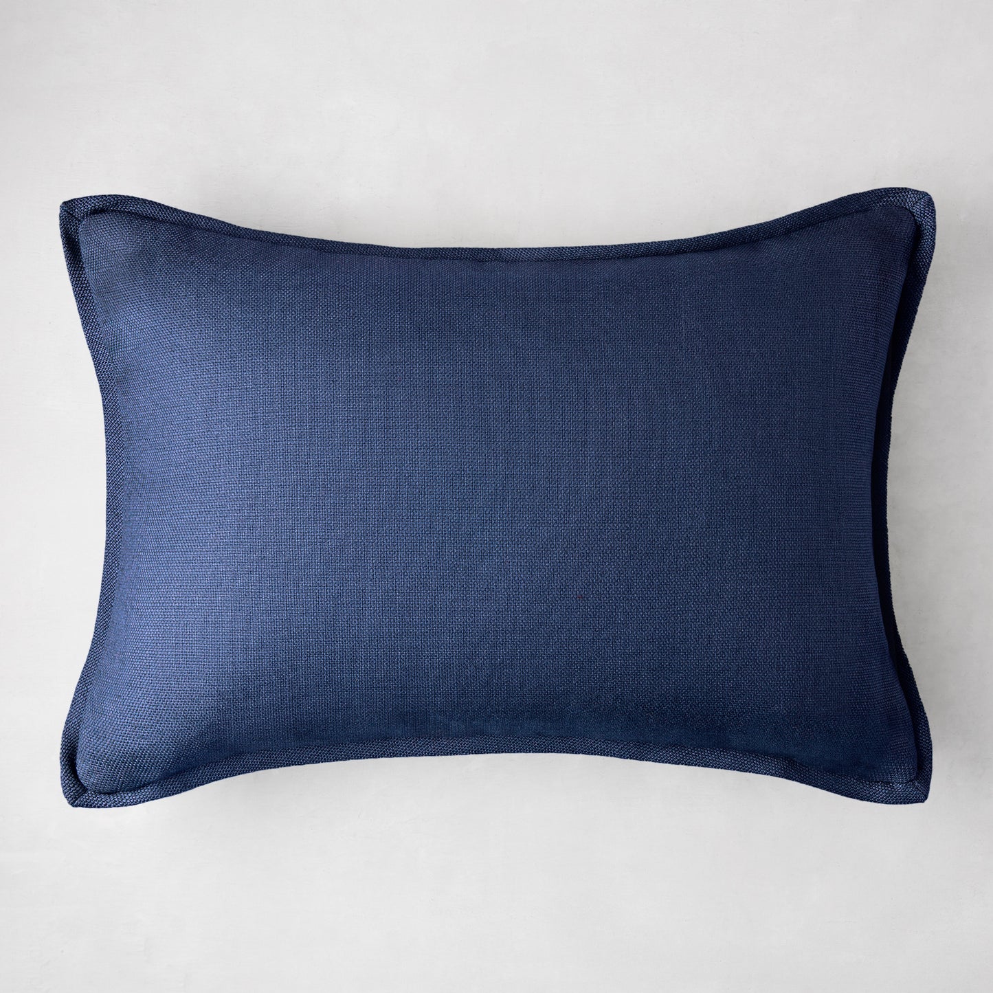 Navy blue linen and velvet reversible lumbar pillow, 20"L x 14"H.