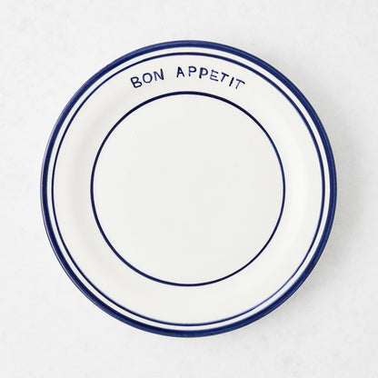 Navy blue and white ceramic salad plate with "Bon Appetit" text and double navy blue rim.