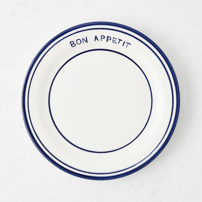 Navy blue and white ceramic salad plate with "Bon Appetit" text and double navy blue rim.