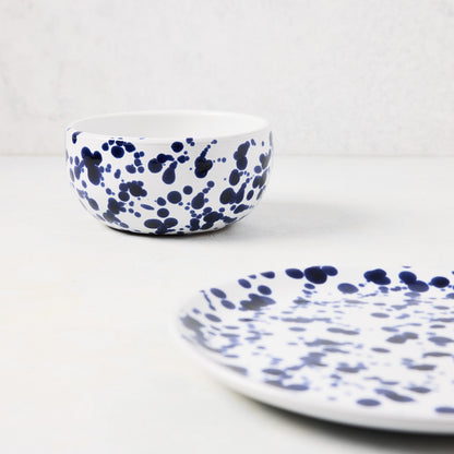 Navy blue splatter stoneware salad plate and matching bowl.