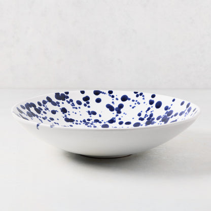 White stoneware serve bowl with navy blue hand-splattered pattern, 12"Dia x 3"H.