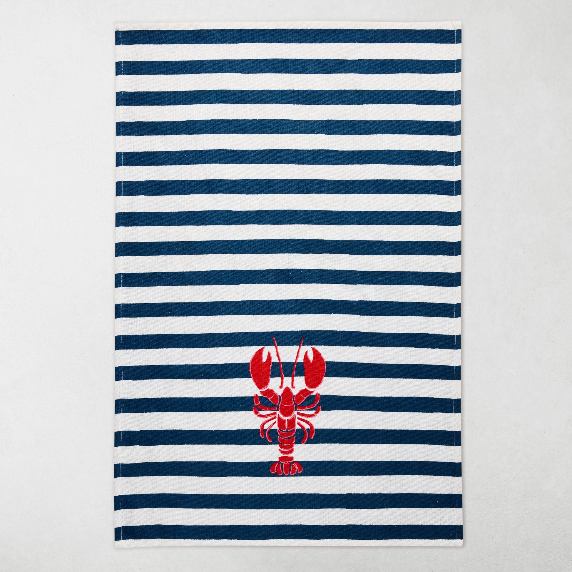 Navy and white striped cotton hand towel with a red lobster design.