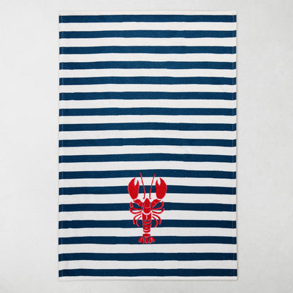 Navy and white striped cotton hand towel with a red lobster design.