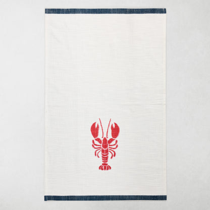 White cotton hand towel with a red lobster print and navy top and bottom borders.