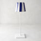 Navy blue and white striped ceramic lamp shade on a white Poldina Pro lamp.