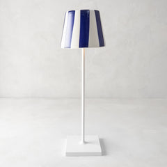 Navy blue and white striped ceramic lamp shade on a white Poldina Pro lamp.