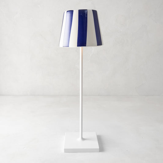 Navy blue and white striped ceramic lamp shade on a white Poldina Pro lamp.