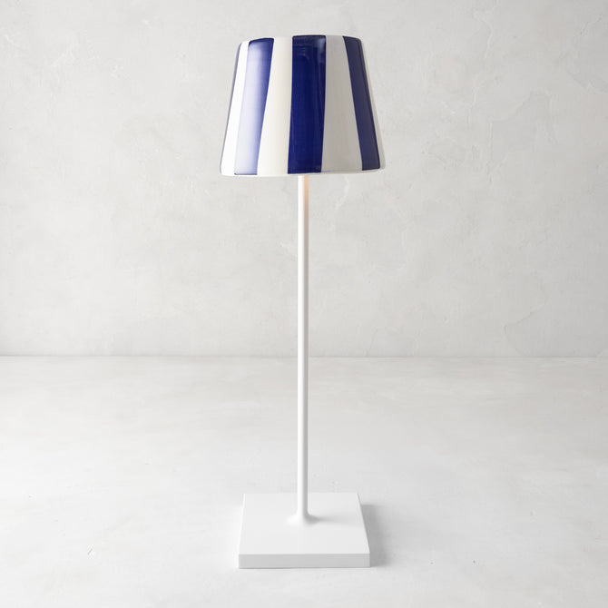 Navy blue and white striped ceramic lamp shade on a white Poldina Pro lamp.