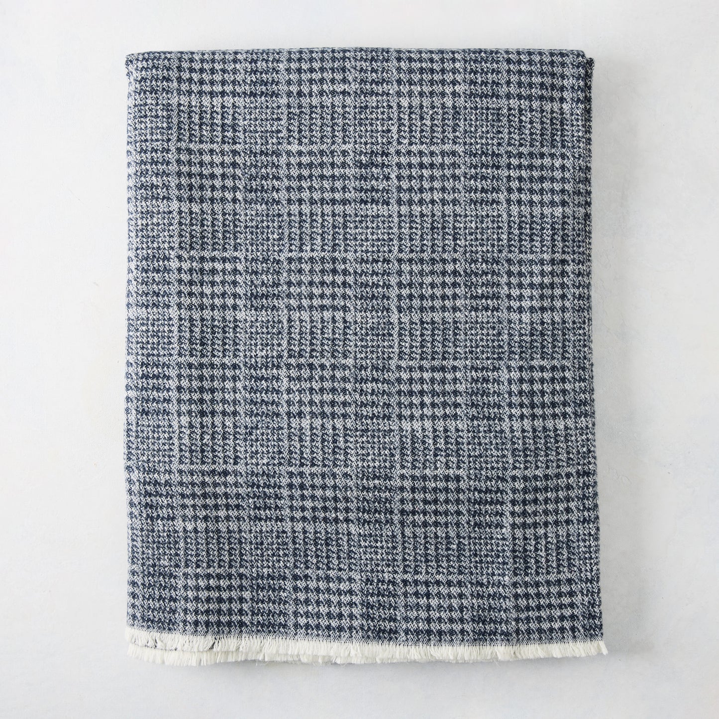 Navy Blue Sutton Houndstooth Throw Blanket, 72"L x 51"W, with fringed edge.