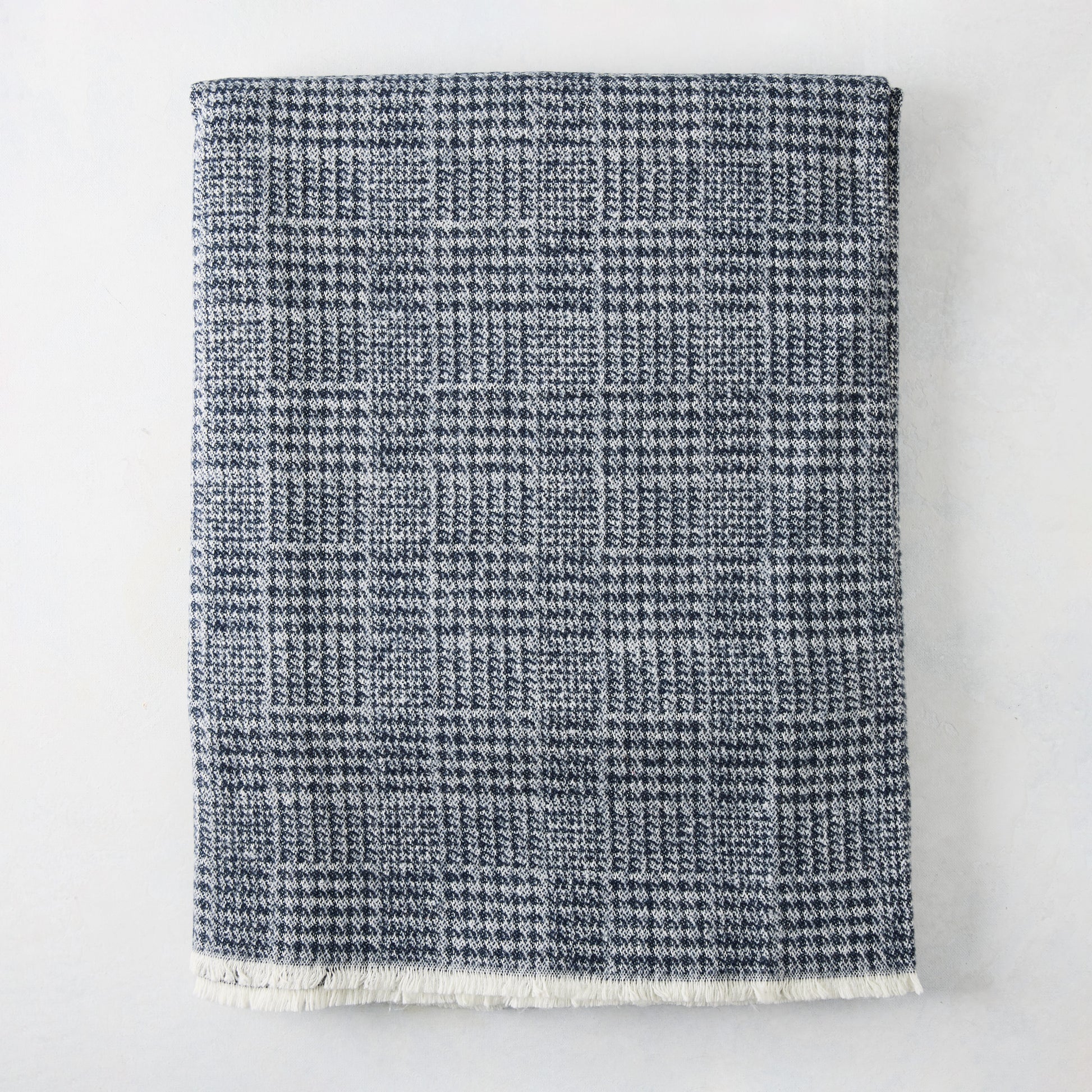 Navy Blue Sutton Houndstooth Throw Blanket, 72"L x 51"W, with fringed edge.
