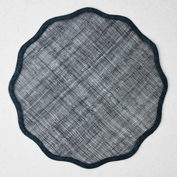 16-inch navy blue round abaca placemat with a semi-transparent woven texture and a scalloped border.