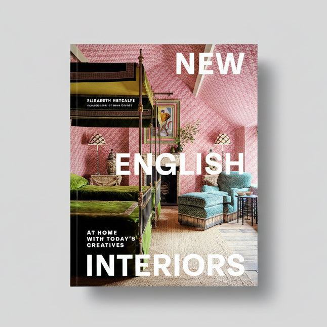 Hardcover book "New English Interiors" with a pink patterned room and green velvet bed on the cover.