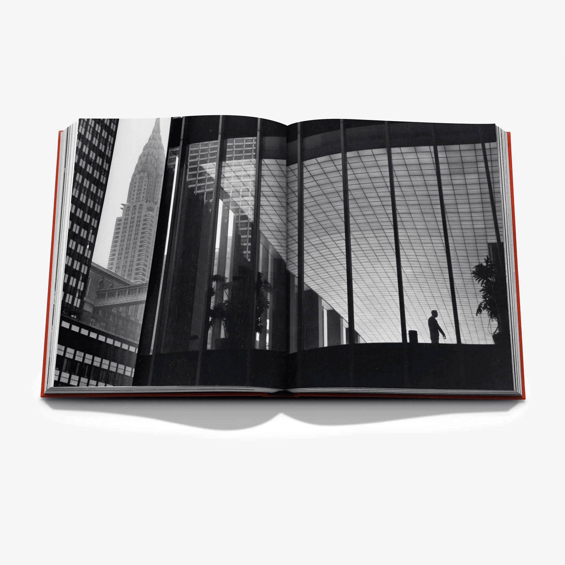 Open "New York By New York" linen hardcover book with black and white cityscape photo spread.