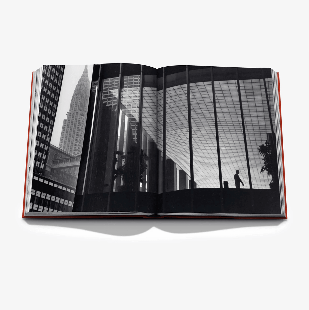 Open "New York By New York" linen hardcover book with black and white cityscape photo spread.