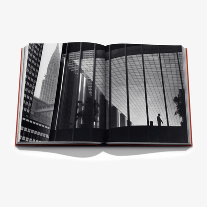 Open "New York By New York" linen hardcover book with black and white cityscape photo spread.