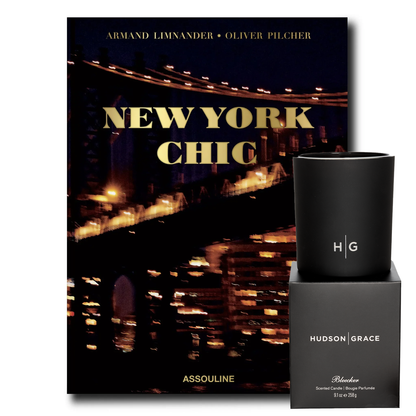 New York Chic book with a dark cover featuring a city bridge at night, next to a black candle and its box.
