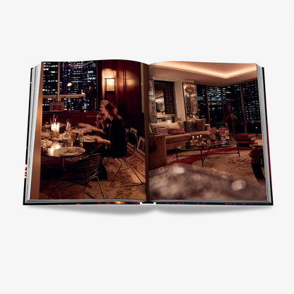 Open "New York Chic" book displaying two interior photos: a dining scene and a living room with city views.