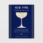 New York Cocktails book with a navy blue cover, gold stripes, and a map of NYC in a cocktail glass silhouette.