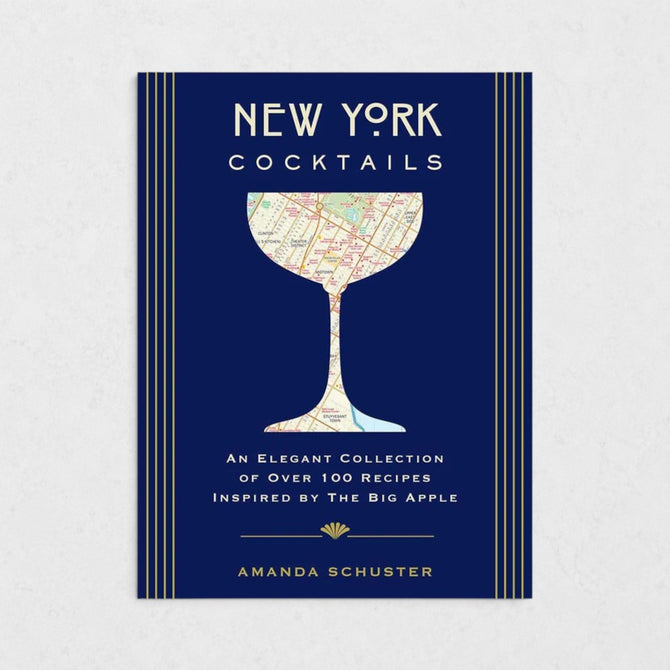 New York Cocktails book with a navy blue cover, gold stripes, and a map of NYC in a cocktail glass silhouette.