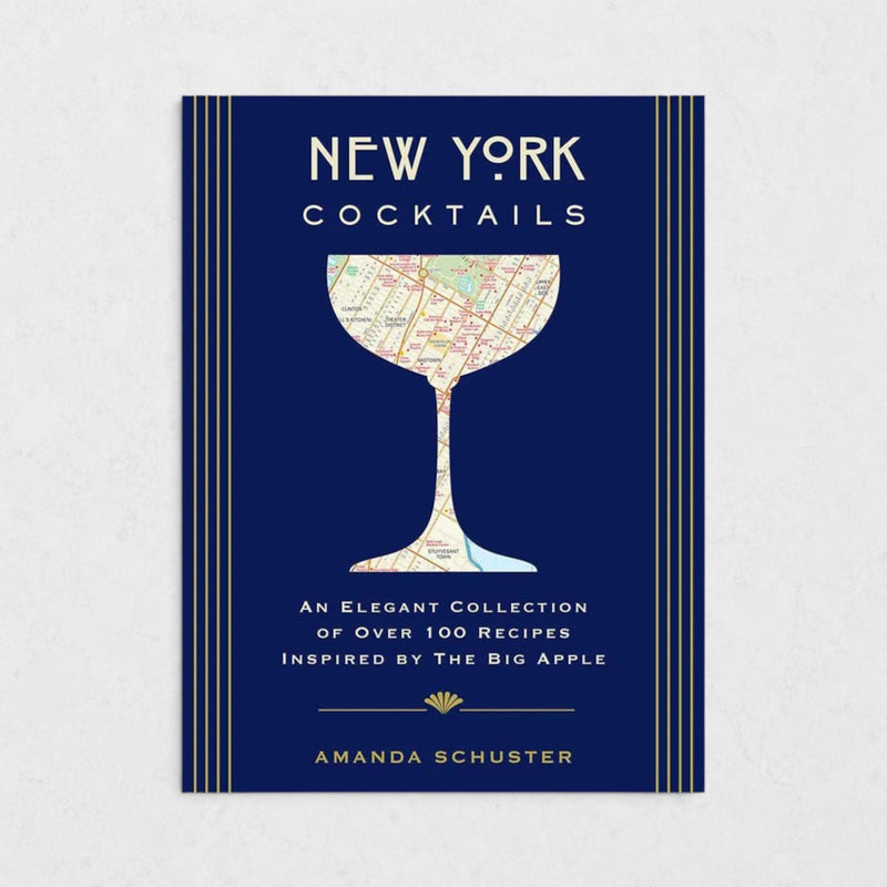 New York Cocktails book with a navy blue cover, gold stripes, and a map of NYC in a cocktail glass silhouette.