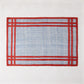 Newport Blue and Red Rectangular Abaca Placemat with a red border, 19"L x 13"W.