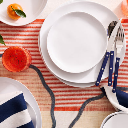 Newport Blue Border Scalloped Placemat, natural abaca with blue scalloped edge, set under white plates.