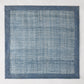 Newport Blue 15" square Abaca placemat with a deeper blue woven border.
