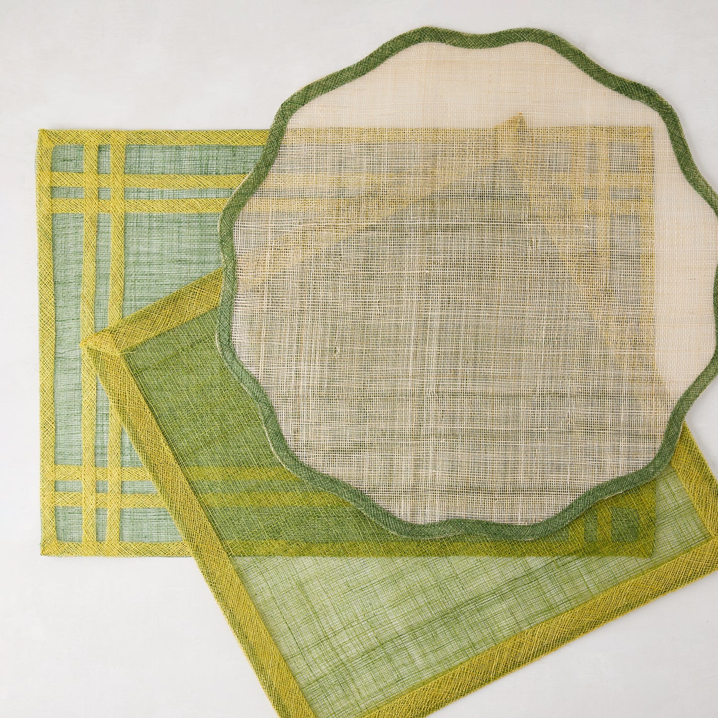 Newport Green Border Scallop Abaca Placemat, 16" Dia, with two other green placemats.