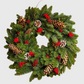 Hudson Grace 18-inch Noble Noel wreath featuring lush green pine needles, natural pinecones, and bright red berries.