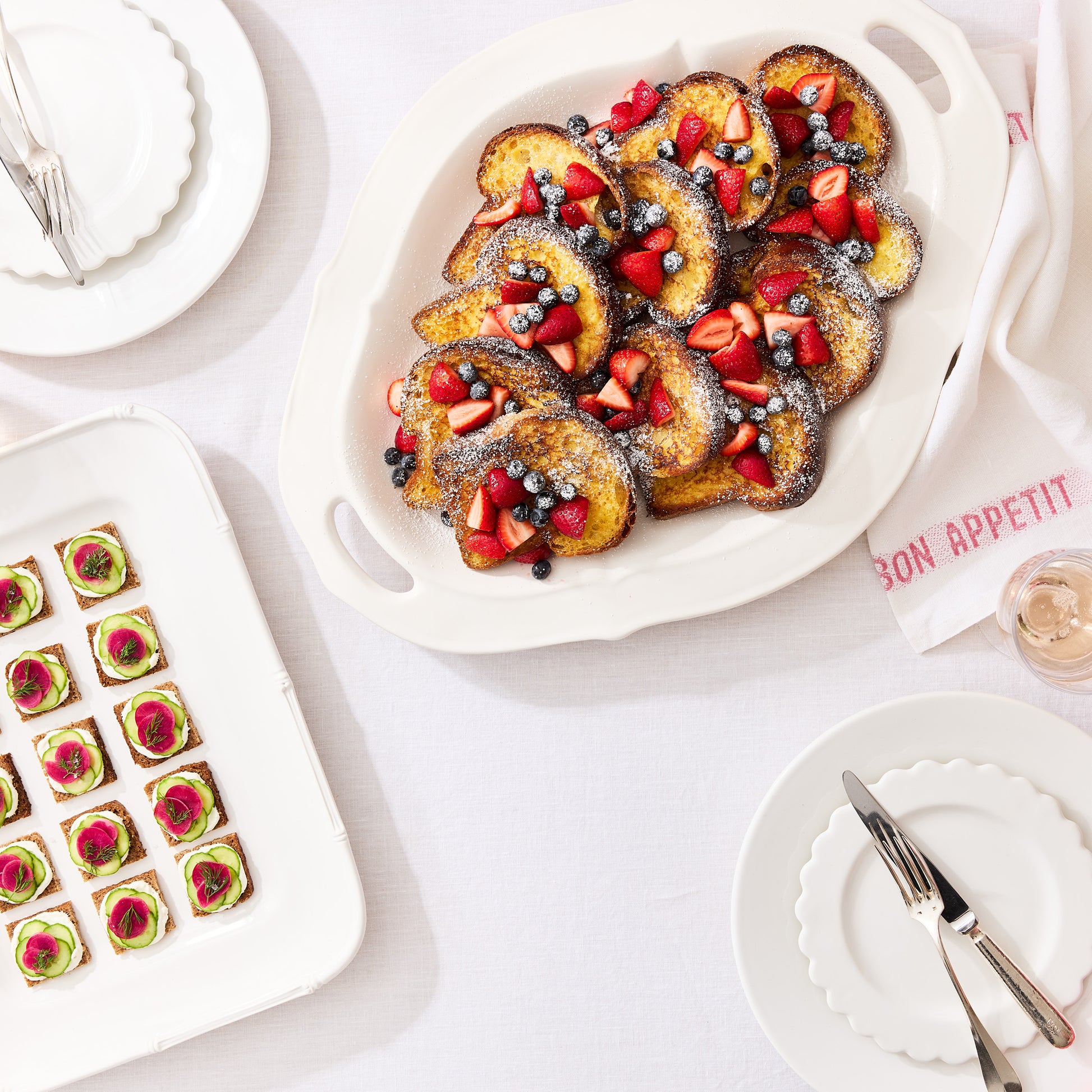White ceramic Nonna serving platter with handles, filled with French toast and berries.