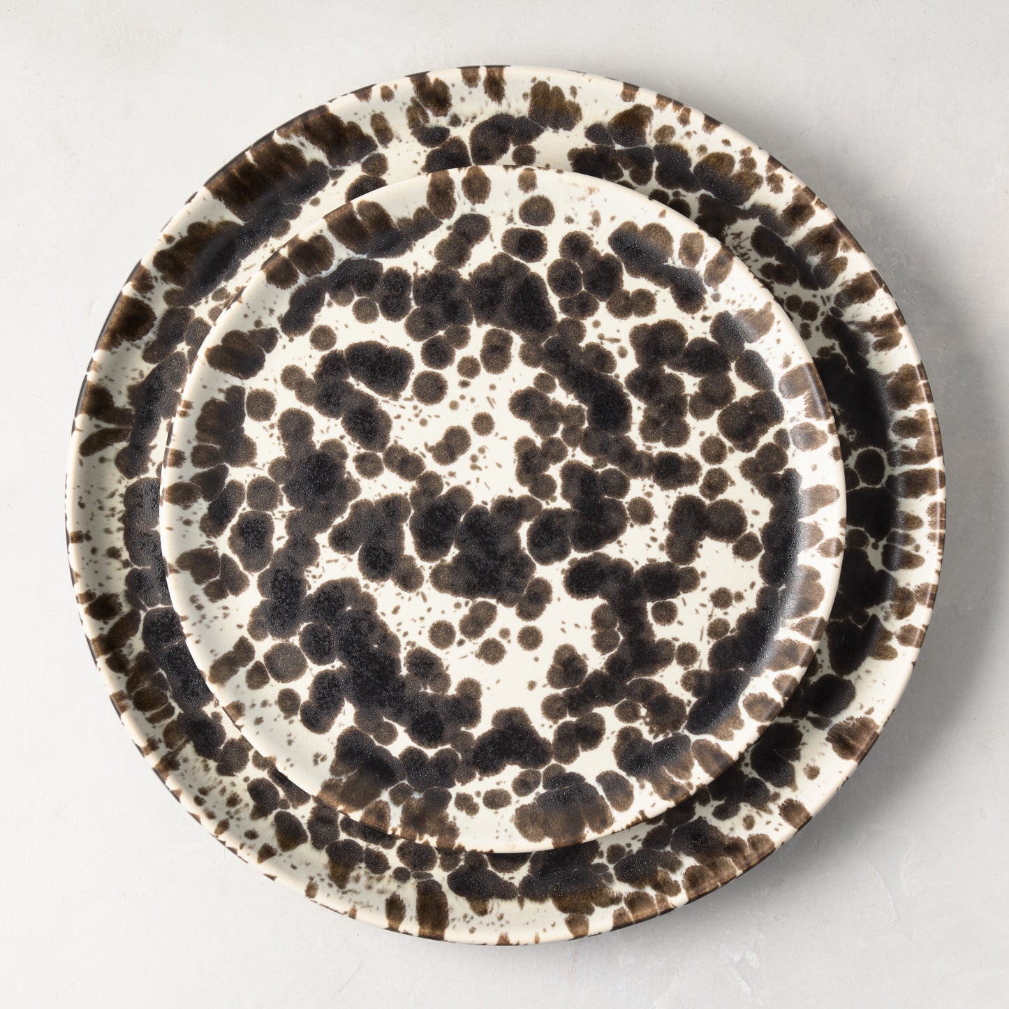 Nuno Splatter stoneware dinner plate with unique brown spots on a pale cream base.