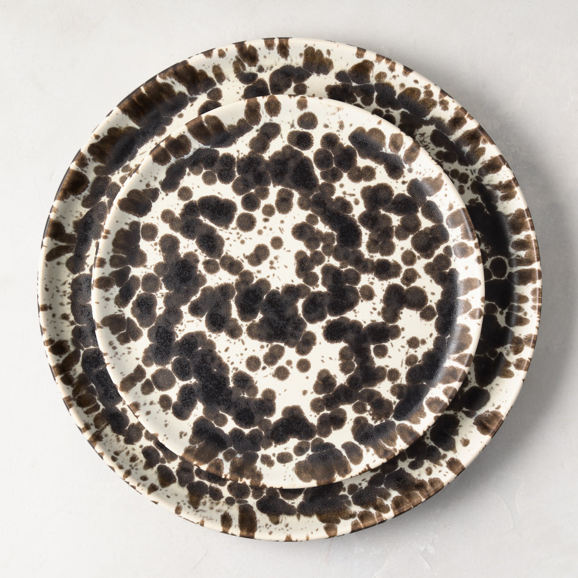 Nuno Splatter stoneware dinner plate with unique brown spots on a pale cream base.