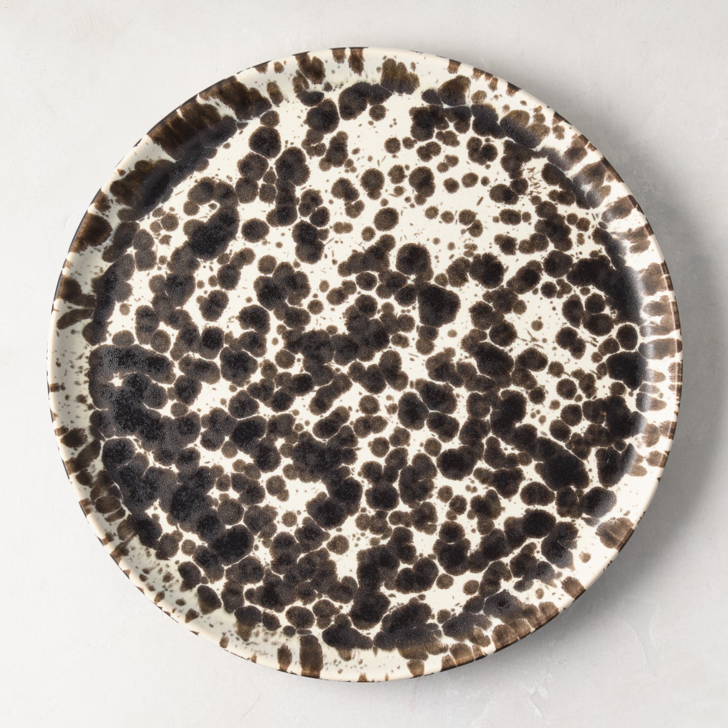 Nuno Splatter 11" stoneware dinner plate with unique brown spots on a pale cream base.